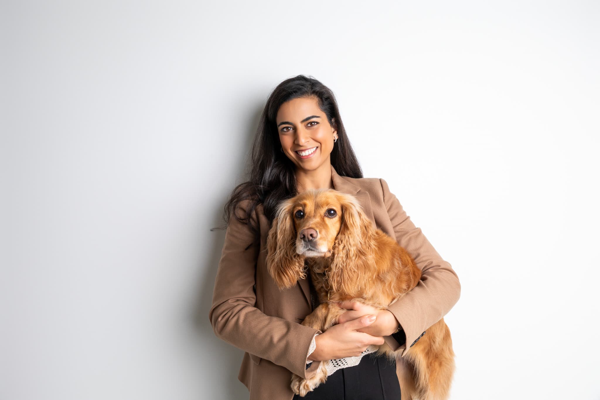 Anjali seated with her dog.